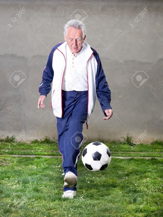 27246087-old-man-in-seventies-kicking-a-soccer-ball-in-courtyard.jpg